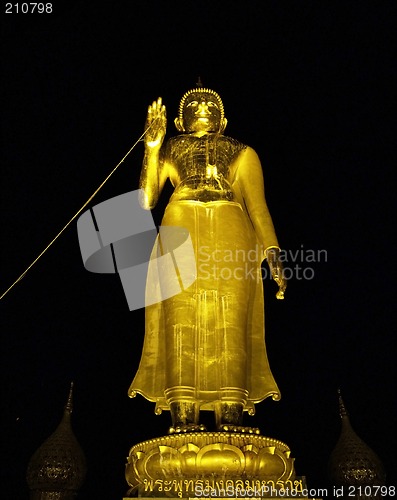 Image of Standing Buddha in the dark