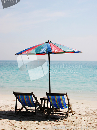 Image of Deck chairs on a white sandy beach