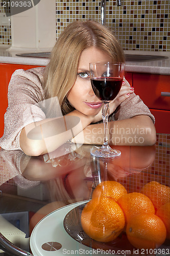 Image of woman in shine dress with glass of wine