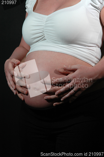 Image of Pregnant woman and hands