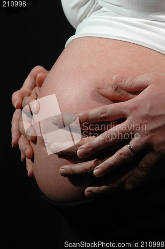 Image of Pregnant woman and hands