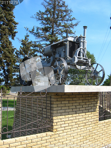 Image of Ancient tractor on a pedestal