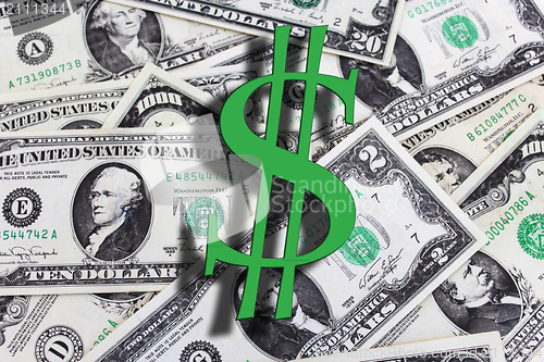 Image of Letter S on a background of dollar banknotes