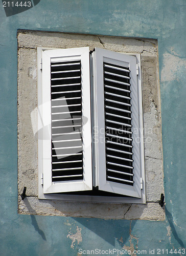 Image of Old window on green wall