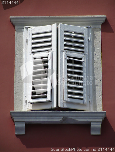 Image of Old window on red wall