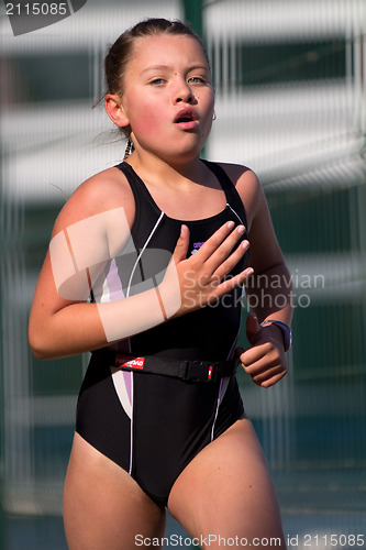 Image of Young female triatlete running