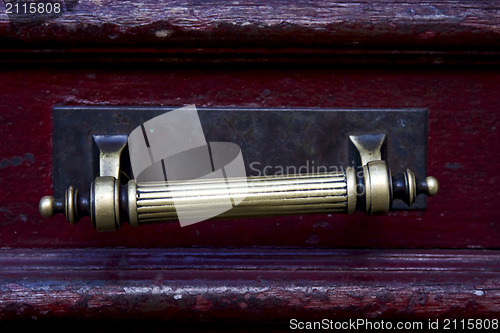 Image of  knocker in a red closed  door