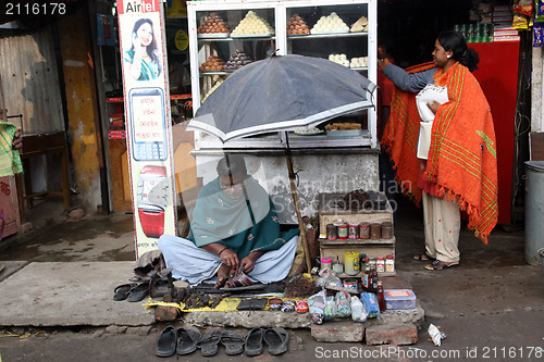 Image of Shoemaker working at the streets of Baruipur, West Bengal, India