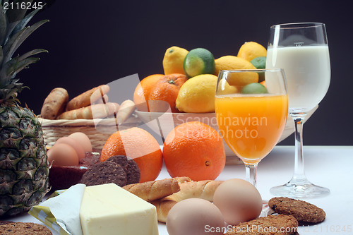 Image of Breakfast with juice, milk, fruits and eggs