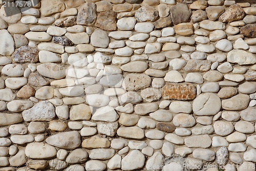 Image of Texture of stone wall built of irregular pebbles 