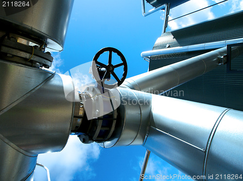 Image of Industrial zone, Steel pipelines and valves against blue sky