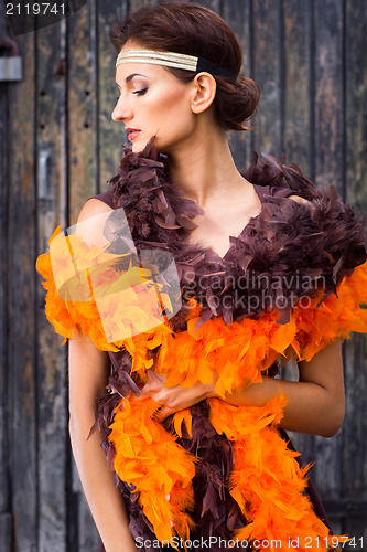 Image of girl in brown and orange boa