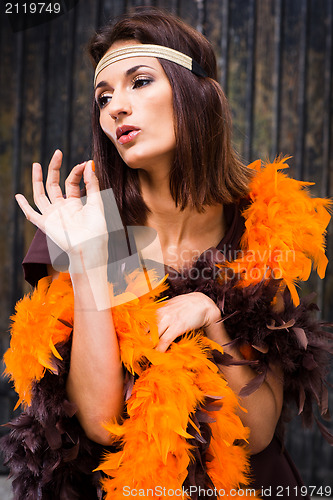 Image of  actress in brown and orange boa