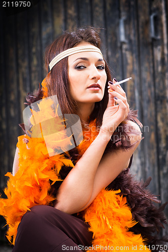Image of smoking actress in brown and orange boa