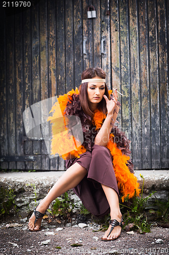 Image of smoking actress in brown and orange boa