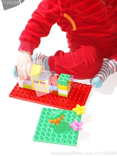 Image of Red dressed kid, playing