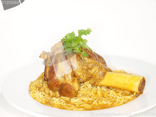 Image of Lamb shank in juicy yellow rice