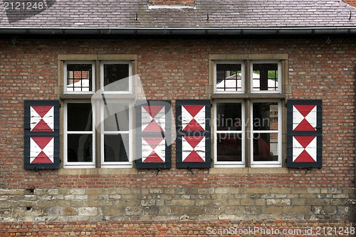 Image of Red brick wall with two windows