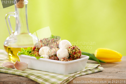 Image of fresh cheese balls with oil and spices