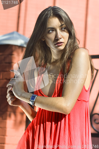 Image of portrait of brunette in coral dress