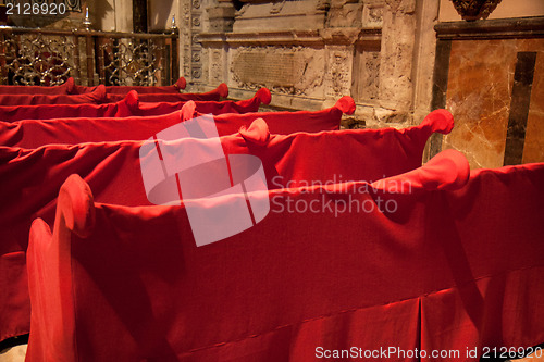 Image of Red sheets on some benches 