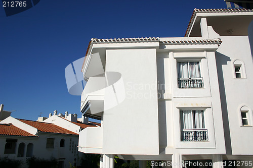 Image of white washed apartment block