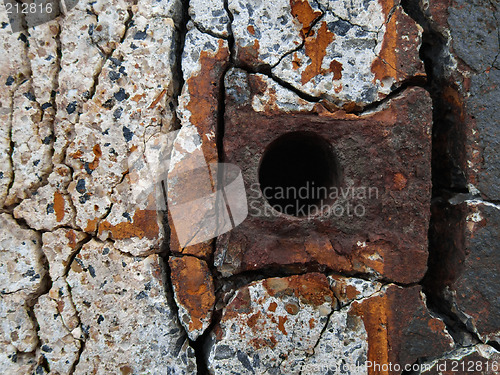 Image of Rusty metal element in concrete wall