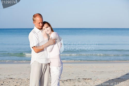 Image of happy couple in love having fun on the beach