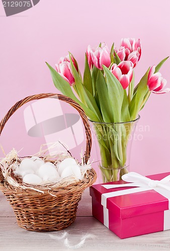 Image of pink present and colorful tulips festive easter decoration