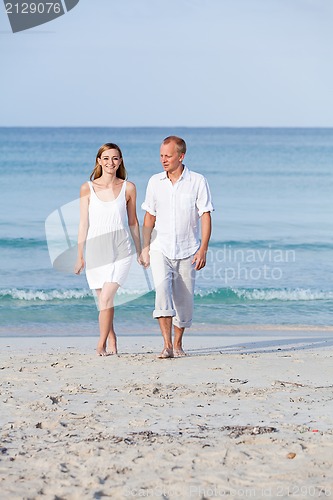 Image of happy couple in love having fun on the beach