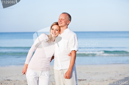 Image of happy couple in love having fun on the beach