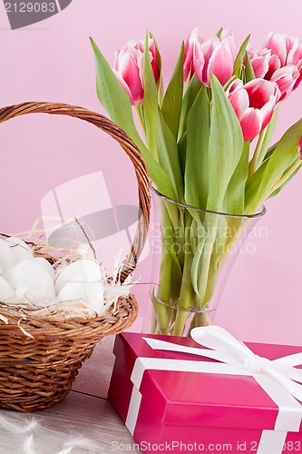 Image of pink present and colorful tulips festive easter decoration