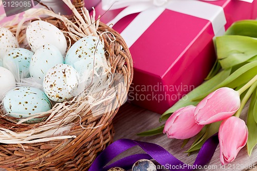 Image of pink present and colorful tulips festive easter decoration