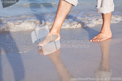 Image of barefoot in the sand in summer holidays