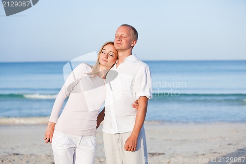 Image of happy couple in love having fun on the beach