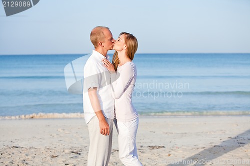 Image of happy couple in love having fun on the beach