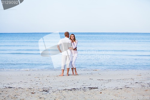 Image of happy couple in love having fun on the beach