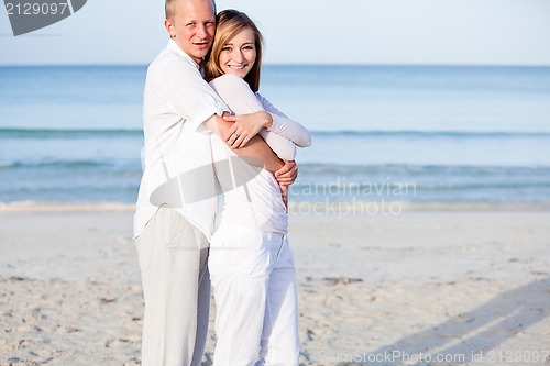Image of happy couple in love having fun on the beach