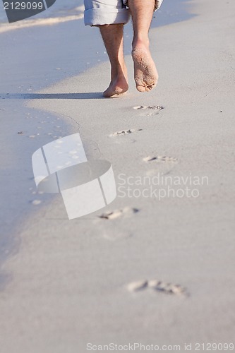 Image of barefoot in the sand in summer holidays