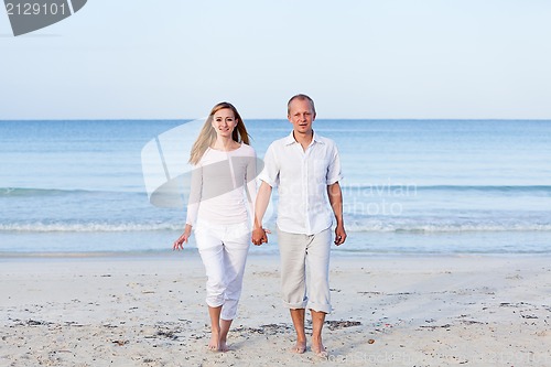 Image of happy couple in love having fun on the beach