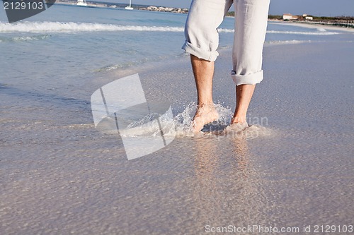 Image of barefoot in the sand in summer holidays