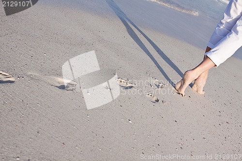 Image of barefoot in the sand in summer holidays