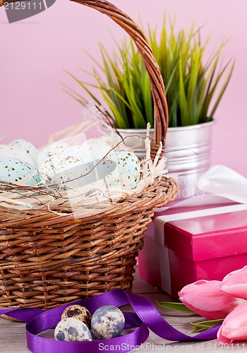 Image of pink present and colorful tulips festive easter decoration