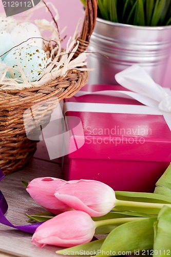 Image of pink present and colorful tulips festive easter decoration