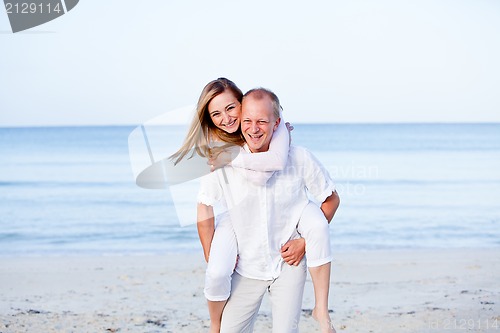 Image of happy couple in love having fun on the beach