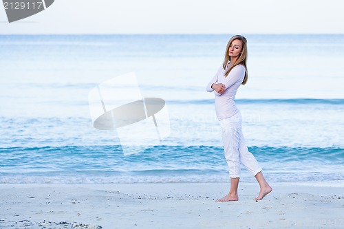 Image of attractive young blonde woman relaxing on the beach
