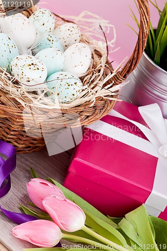 Image of pink present and colorful tulips festive easter decoration