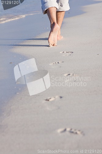 Image of barefoot in the sand in summer holidays