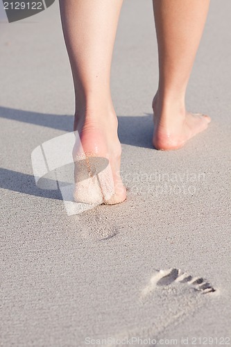 Image of barefoot in the sand in summer holidays