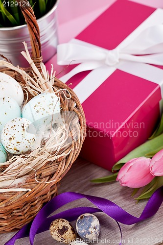 Image of pink present and colorful tulips festive easter decoration
